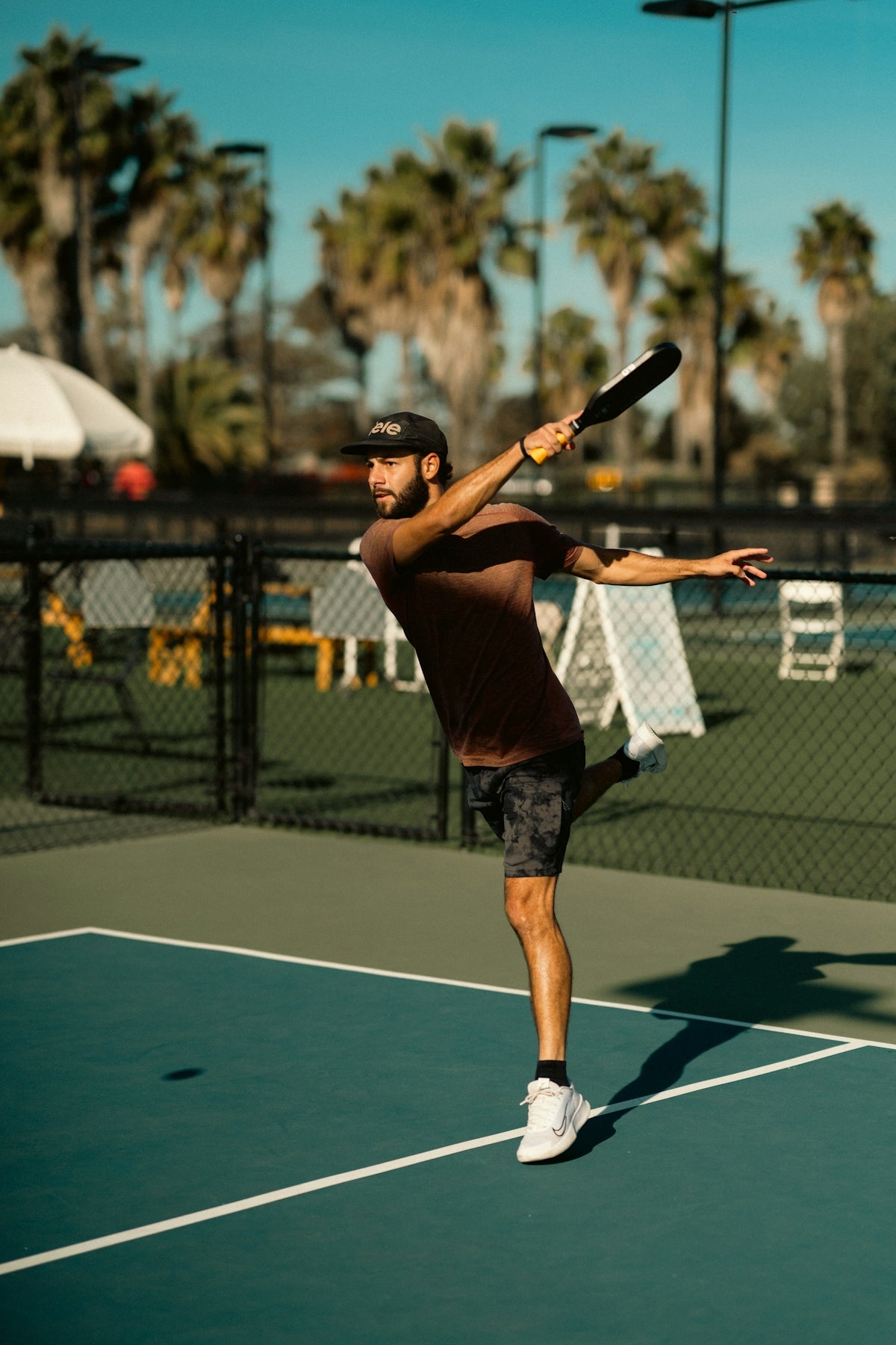A man swinging a tennis racquet on a tennis court